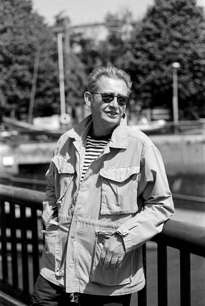 istock Senior man wearing sunglasses and light jacket leaning on railing 2216981589