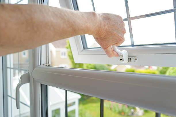 istock Homeowner seen pulling shut a newly installed double glazed window with leaded flashing. 2216984286