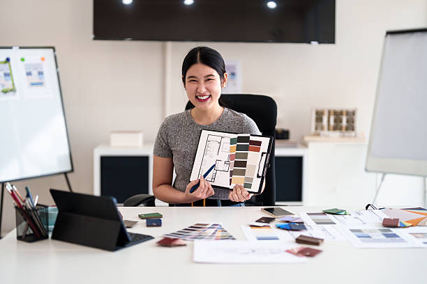 istock Young architect presenting interior design ideas through tablet during online meeting in creative office 2216985908