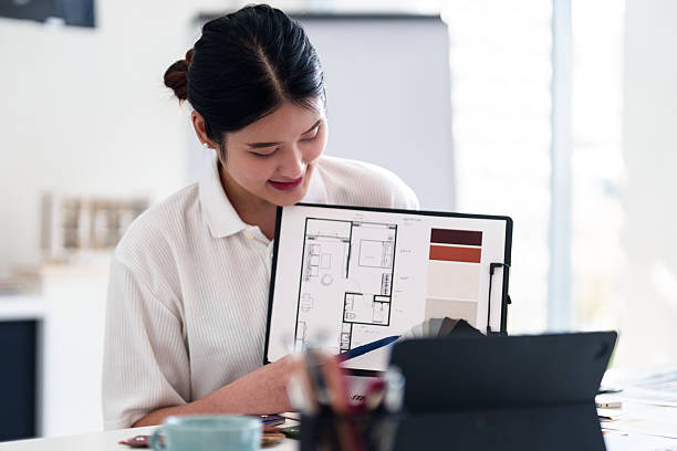 istock Young architect presenting interior design ideas through laptop during online meeting in creative office 2216985985