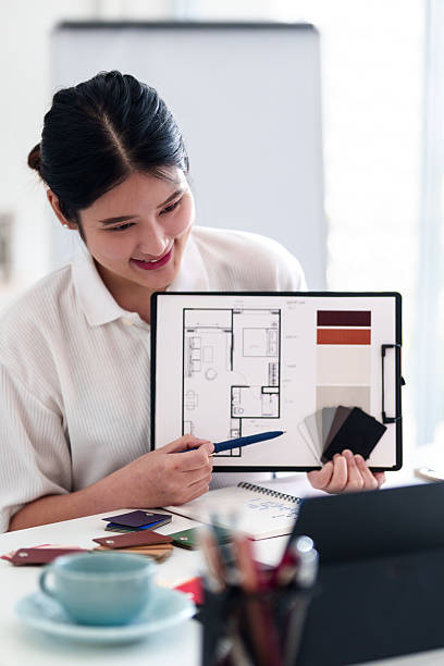 istock Young architect presenting interior design ideas through laptop during online meeting in creative office 2216985986