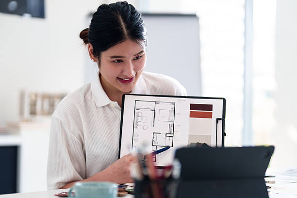 istock Young architect presenting interior design ideas through laptop during online meeting in creative office 2216985988