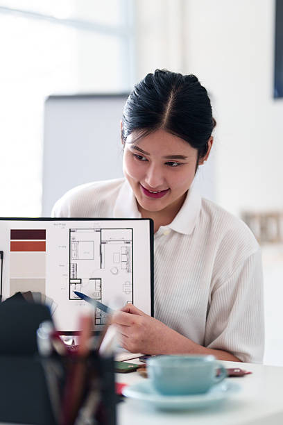 istock Young architect presenting interior design ideas through laptop during online meeting in creative office 2216985993