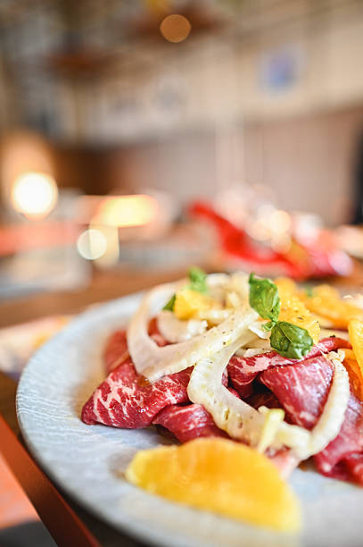 Delicious carpaccio with orange and fennel in a restaurant setting