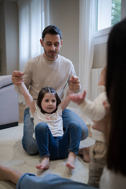 istock Father playing with daughters in the living room 2216986914