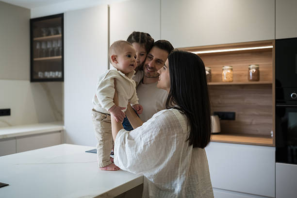 istock Happy family playing with baby in modern kitchen 2216987111