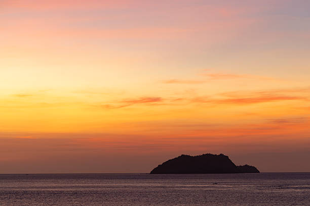 beautiful sunset island silhouette, komodo national park, indonesia.