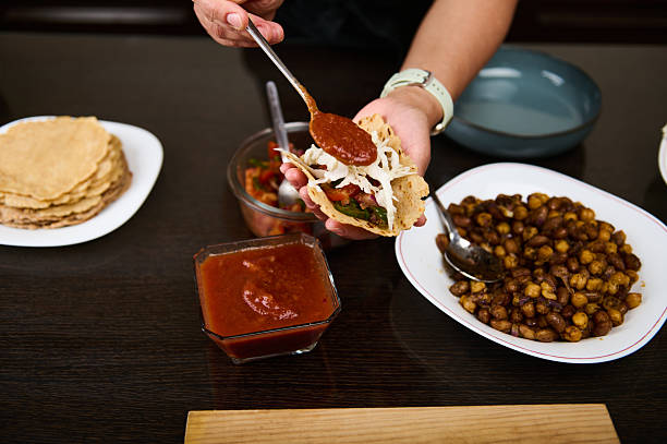 istock Preparing Vegetarian Tacos with Roasted Beans and Fresh Salsa 2216989002