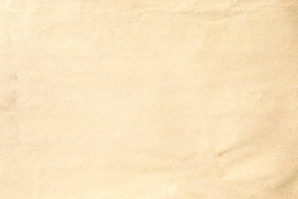 istock Crumpled texture of a pale beige paper sheet 2216991197