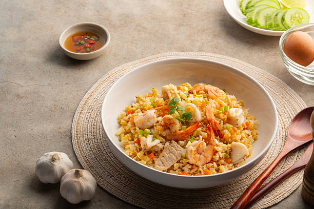 istock Thai fried rice with pork shrimp and squid in a plate. 2216994317
