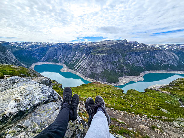 Scenic viewpoint overlooking turquoise lakes in Norway during a cloudy day