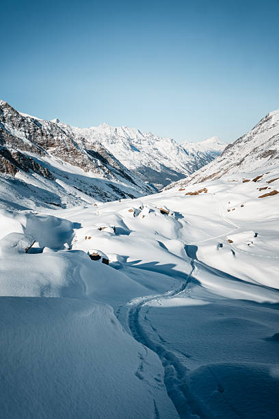 Ski tracks leading towards glaciated mountain, Saas Fee, Valais Canton, Swiss Alps