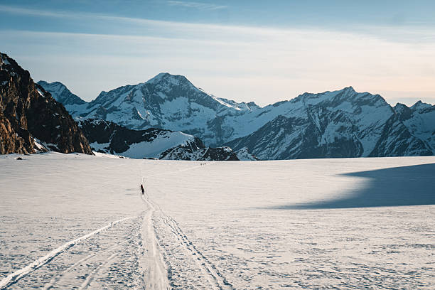 istock Ski mountaineer and ski tracks on glaciated mountain 2216998992