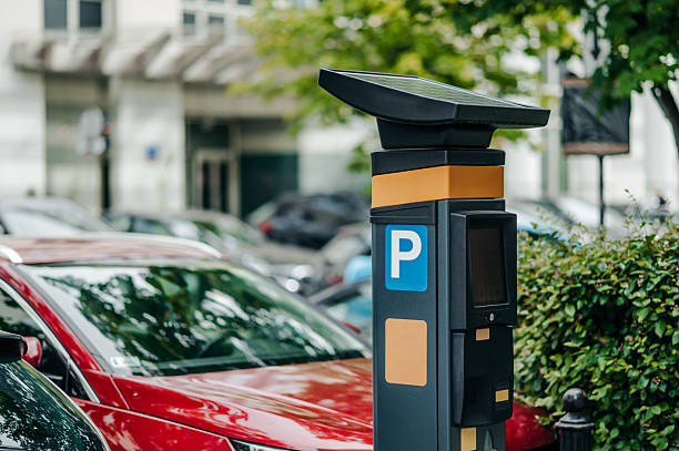 istock A solar-powered parking meter is located in an urban environment filled with parked vehicles under bright sunlight 2217003180
