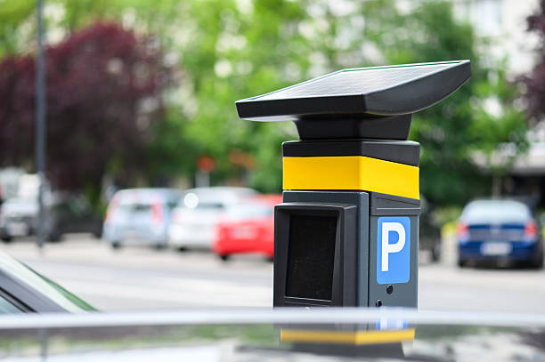 istock Parking meter equipped with solar panel stands in an urban setting, highlighting efficient, eco-friendly technology for city parking management 2217003380