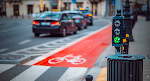 istock Bicycles receive a green signal while vehicles wait at a bustling urban intersection in the evening, highlighting bike-friendly infrastructure 2217004051