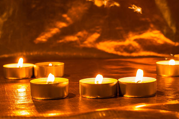 Many burning candles shine warmly together. Candles New Year sparkle in the dark, bringing hope. Valentine candle lights bring a moment of tenderness and love on Valentine's Day.