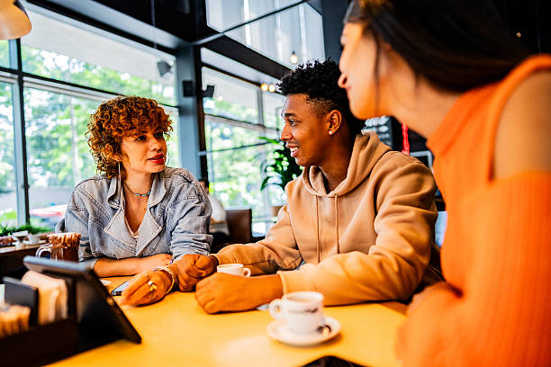 istock Coworkers talking at coffee shop 2217004296