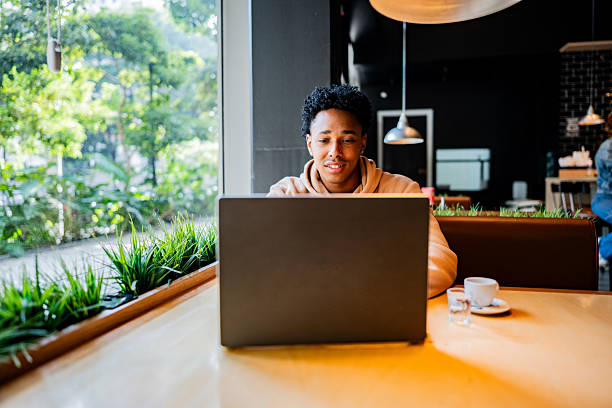 istock Young man working using laptop at coffee shop 2217004918