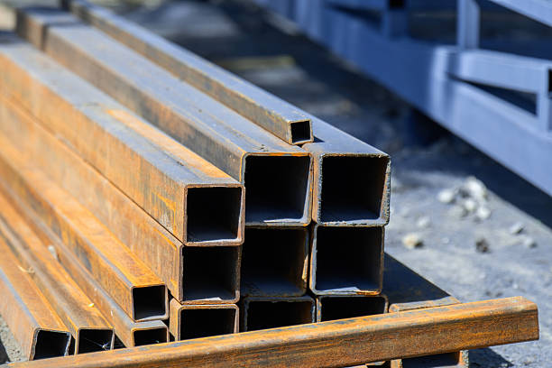 istock Square profile steel pipes stacked at a construction site, ready for building or structural projects 2217005124