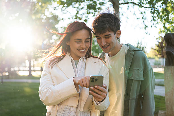 istock Smiling friends enjoying a moment outdoors on a sunny day 2217007527