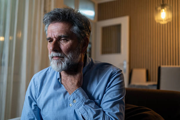 istock Sick mature aged man feeling sore throat 2217008283
