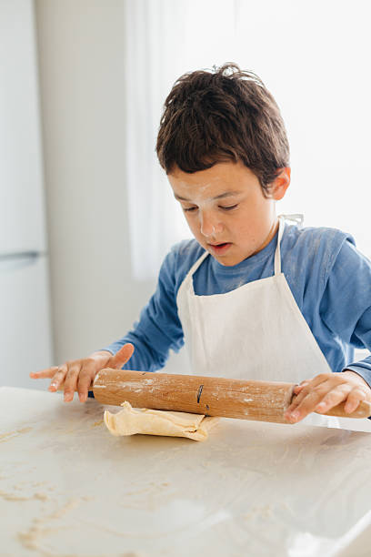 istock Little Chef in Action: Dough Playtime in the Kitchen 2217010749