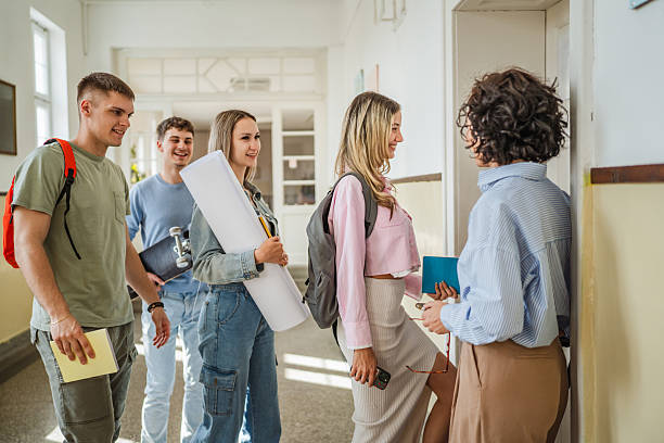 istock The teacher welcomes the students as they enter the classroom 2217011220
