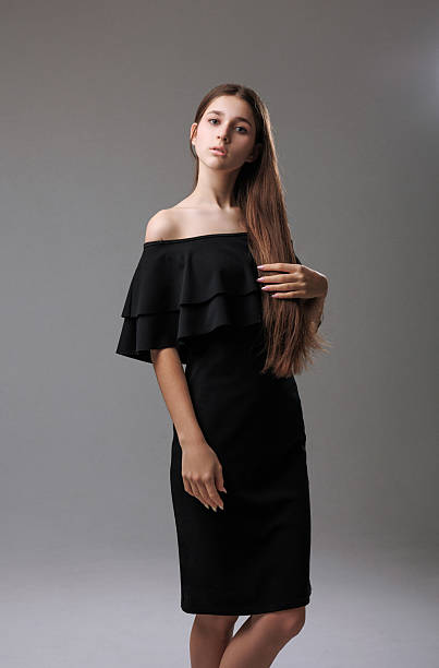 Unrecognizable beautiful young Caucasian woman in a black-white prom dress