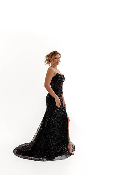 istock Elegant woman in a sparkling black gown posing gracefully in a studio setting 2217013531
