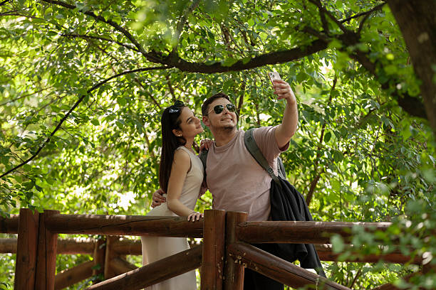 istock Couple taking a selfie in the park 2217015122