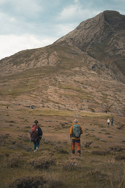 istock Hikers walking towards majestic mountain peak in a cloudy day 2217017529
