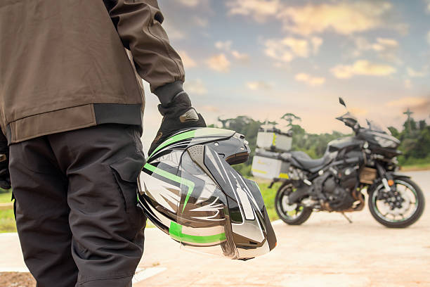 istock Biker helmet and motorcycle in blur background 2217022815