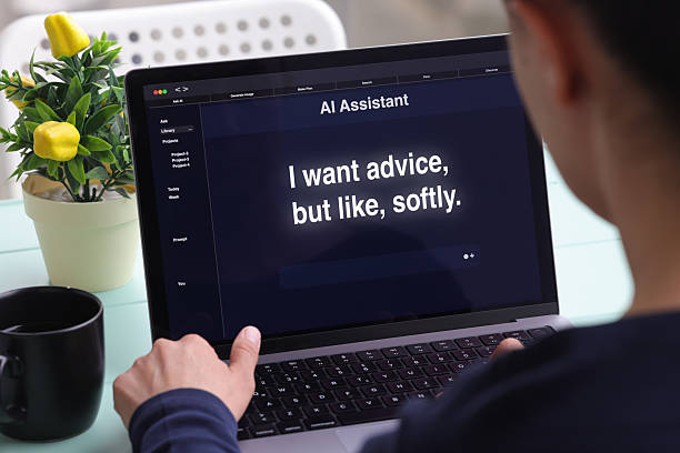 istock Young adult using AI assistant app with humorous self-help prompt on laptop screen 2217024868