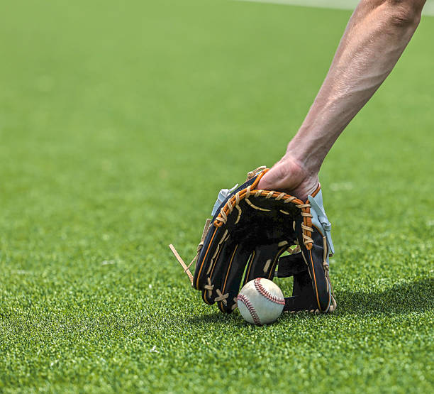 istock Playing catch on a baseball field 2217025072