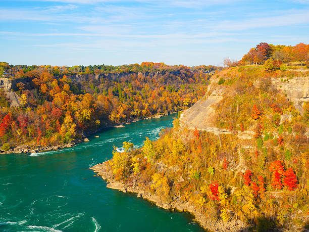 istock Fall background. Landscape during day light. Autumn trees on the river bank. Mountains and forest. Vivid colours in the forest. Banff National Park, Alberta, Canada. 2217027147