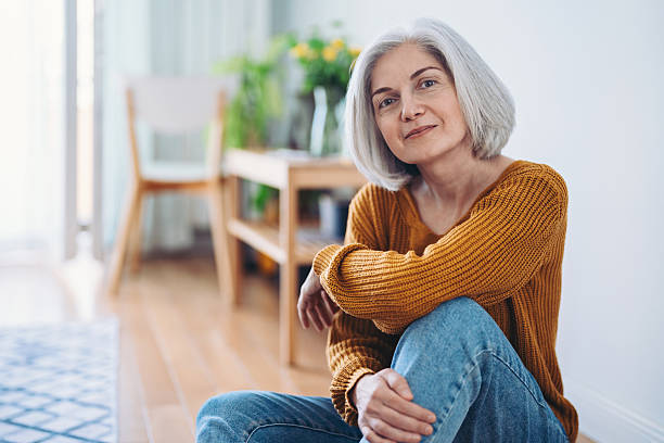 istock Mature woman sitting at home, looking confident and content 2217028438