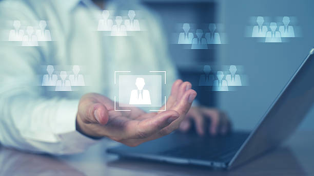 istock Digital interface showing user group icons floating above a businessman's hand. Concept of CRM, HR system, user management, team network, or social data. 2217028529