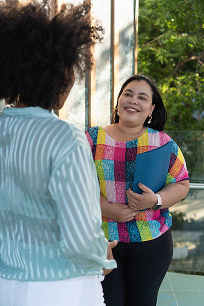 istock Two businesswomen talking outside office building 2217028819