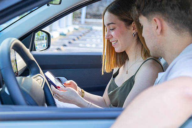istock Young couple setting up gps navigation on smartphone inside car 2217030408