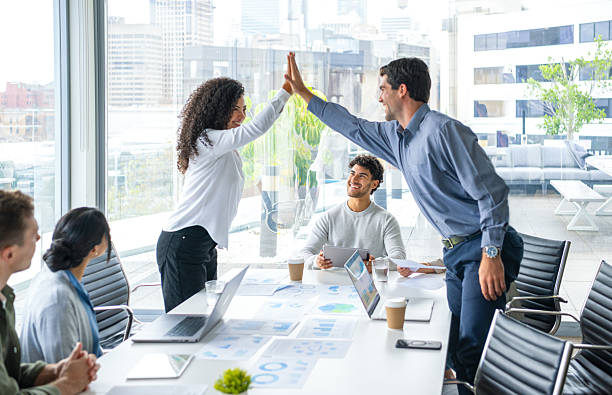 istock Business team members giving each other a high five celebration 2217031762