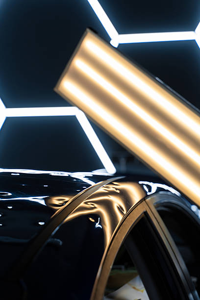istock Car panel shows multiple dents under PDR lighting, used in paintless dent repair to expose imperfections. PDR lights reveal damage for accurate dent detection and assessment. 2217032536