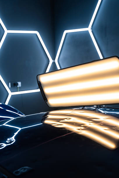 istock PDR lights reveal damage for accurate dent detection and assessment. Car panel shows multiple dents under PDR lighting, used in paintless dent repair to expose imperfections. 2217032544