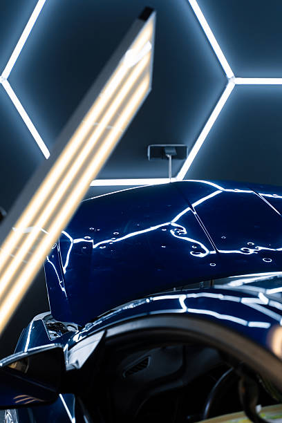 istock PDR lights reveal damage for accurate dent detection and assessment. Car panel shows multiple dents under PDR lighting, used in paintless dent repair to expose imperfections. 2217032636