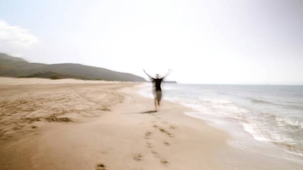 Blurred Man Running Joyfully on the Beach by the Sea