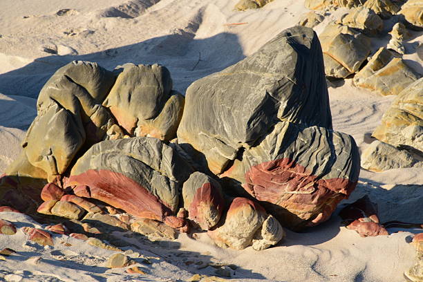 Rocky Formations on Sandy Betty's bay beach with Natural Textures Highlighted by sunset Shadows