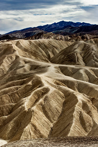 Dramatic erosional landscape in the area of Zabriskie Point at the Death Valley National Park in California carved by millions of years of wind and water activity.