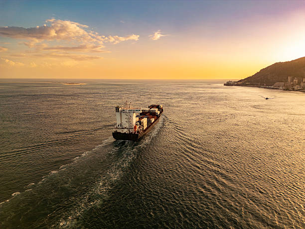 istock Cargo ship at sunset in the sea 2217037036