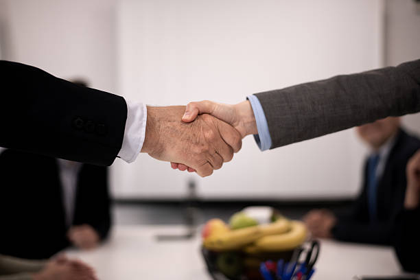 istock Professional handshake between colleagues in a modern office setting during a business meeting 2217040446