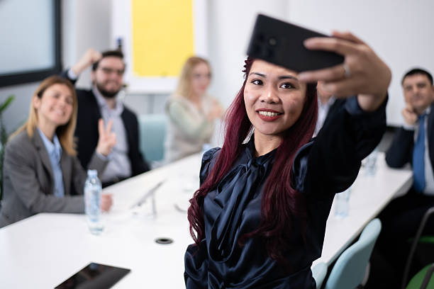 istock Employees taking a selfie during an office meeting, showcasing teamwork and camaraderie 2217040509